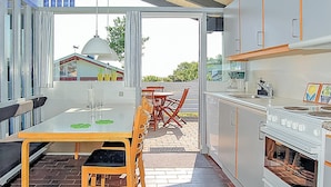 A modern kitchen with a dining area, large windows, and a view of the outside. - Lovely home in Aabenraa with house sea view (Aabenraa)