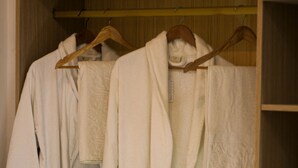 Une armoire en bois avec plusieurs compartiments pour suspendre des vêtements.