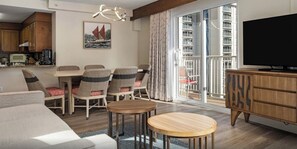 A modern living room with a dining area, a television, and a balcony with a view of high-rise buildings. - One BR Resort at Wyndham Beach Walk – Waikiki Beach, HI
A Perfect Spring Break! (Honolulu, Oahu)