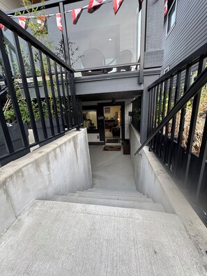 A staircase leading to a second-floor area with a view of the outside. - Luxe 2BD Suite/Sweet Spot in South Surrey (Surrey)