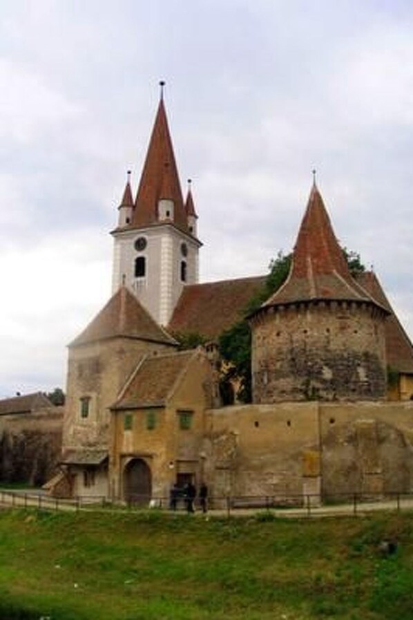 A historic building with a central tower and a fortified structure.