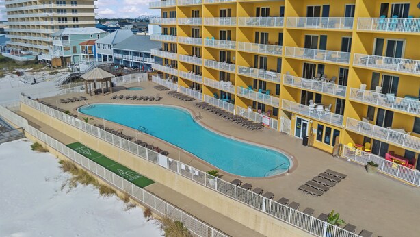 A hotel with a pool, multiple balconies, and a beach view. - Beach Front Luxury Condo w/ Stunning Emerald Coast Views 2/ Kings (Panama City Beach)