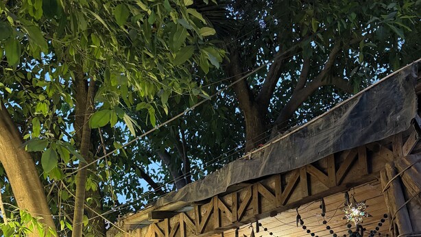 A wooden structure with a circular sign reading "Sayu LIFE HOTEL & LIFESTYLE" and a star decoration. - Sayu Life (Sayulita)
