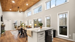 A spacious kitchen with a central island, large windows, and a wooden ceiling. - Private | Hot Tub | Stargazing | Mountain View (Stanton)