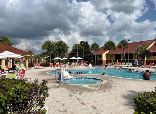 A pool area with multiple pools, lounge chairs, and umbrellas. - LUXURY VILLA RESORT MINUTES FROM DISNEY SLEEPS 10-12 (Kissimmee)