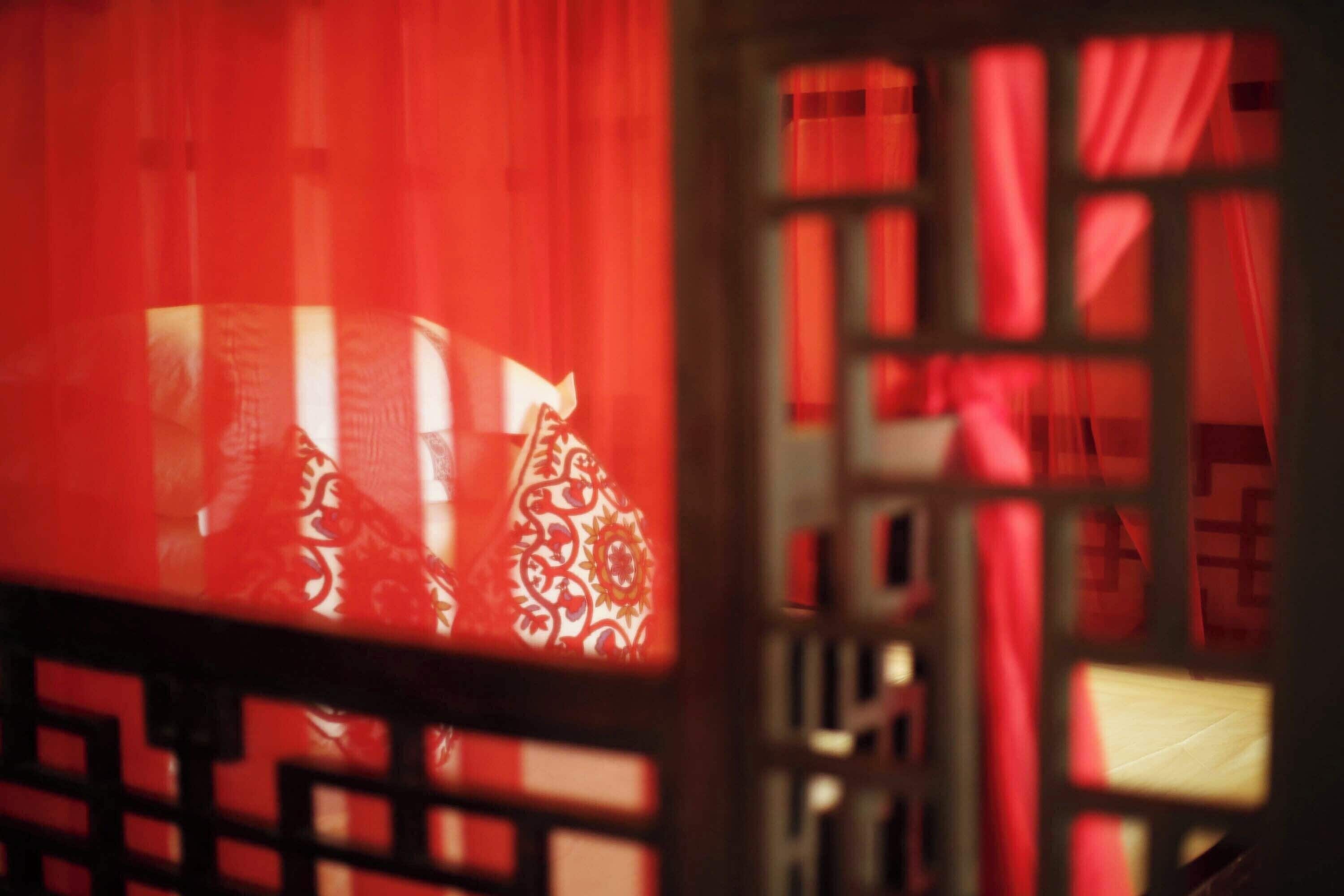 A traditional Chinese window with intricate lattice design.