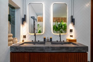 A modern bathroom with two sinks, wooden vanity, and mirrors. - Villa Sevu 5 (Cemagi)