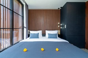 A modern bedroom with a large bed, two pillows, and a nightstand. - Villa Sevu 8 (Cemagi)