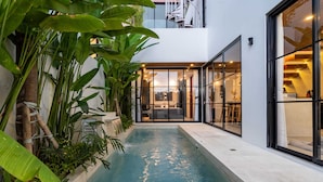 A modern building with a pool, surrounded by lush greenery. - Villa Sevu 4 (Cemagi)