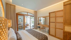 A bedroom with a bed, a desk, and a large window. - Villa Jackie O (Seminyak)