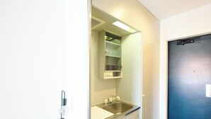 A modern bathroom with a sink, mirror, and cabinets. - Hotel Stripe Sapporo (Sapporo)
