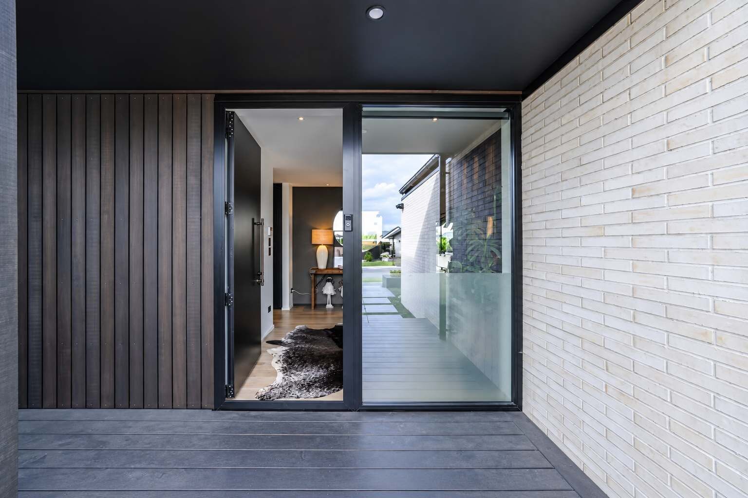 A modern interior with a sliding glass door leading to a balcony.