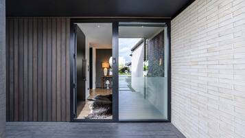 A modern interior with a sliding glass door leading to a balcony.