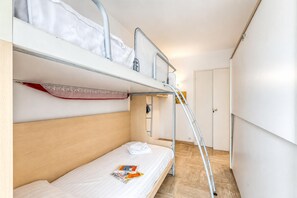 A bunk bed room with a ladder, a door, and a magazine on the lower bunk. - Cannes Sea View - Port du Moure Rouge, Cannes, France (Cannes)