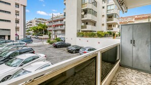 A parking area with multiple cars, a building with balconies, and a clear sky. - Cannes Sea View - Port du Moure Rouge, Cannes, France (Cannes)