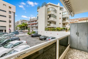 A parking area with multiple cars, a building with balconies, and a clear sky. - Cannes Sea View - Port du Moure Rouge, Cannes, France (Cannes)