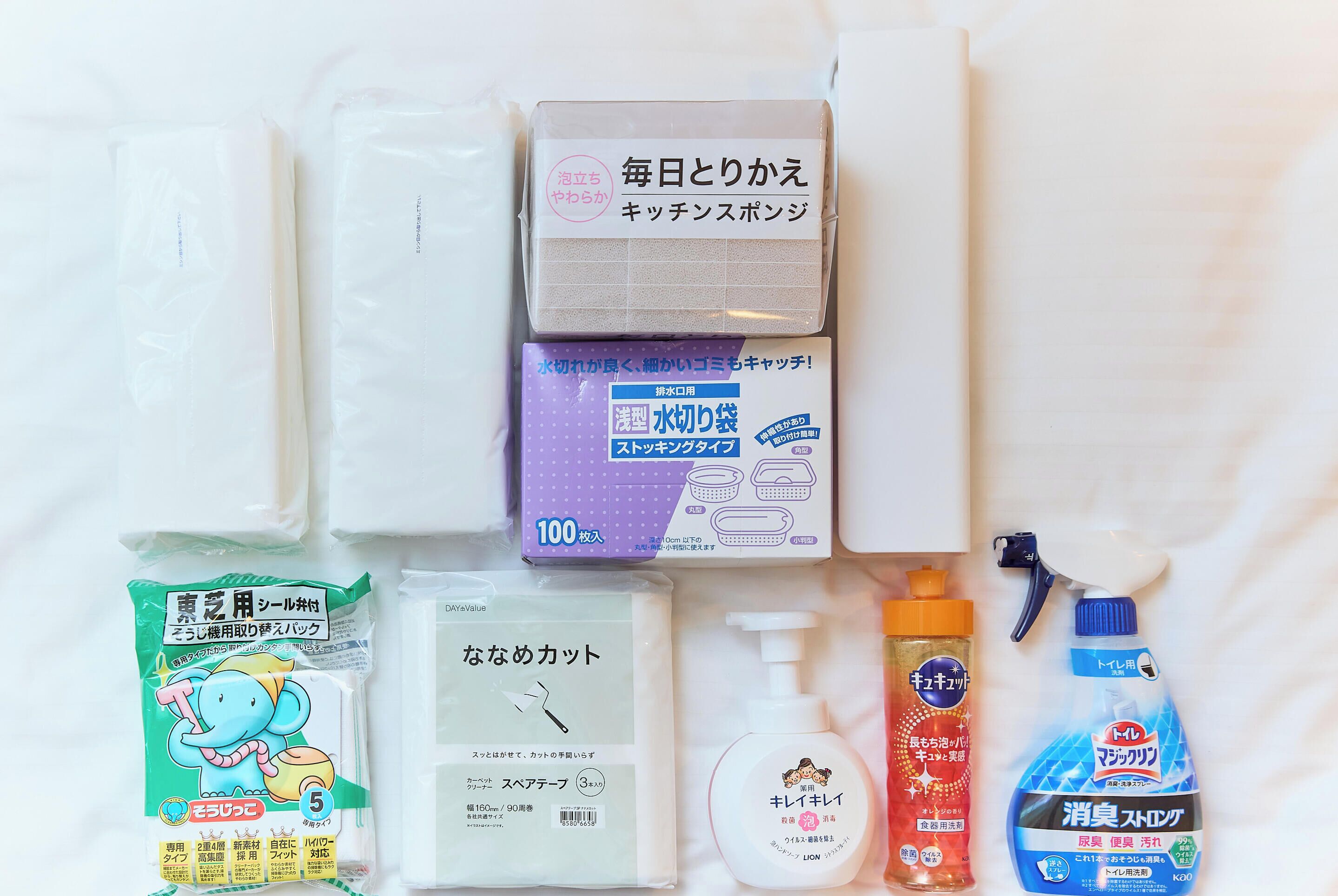 A variety of personal care items laid out on a bed.