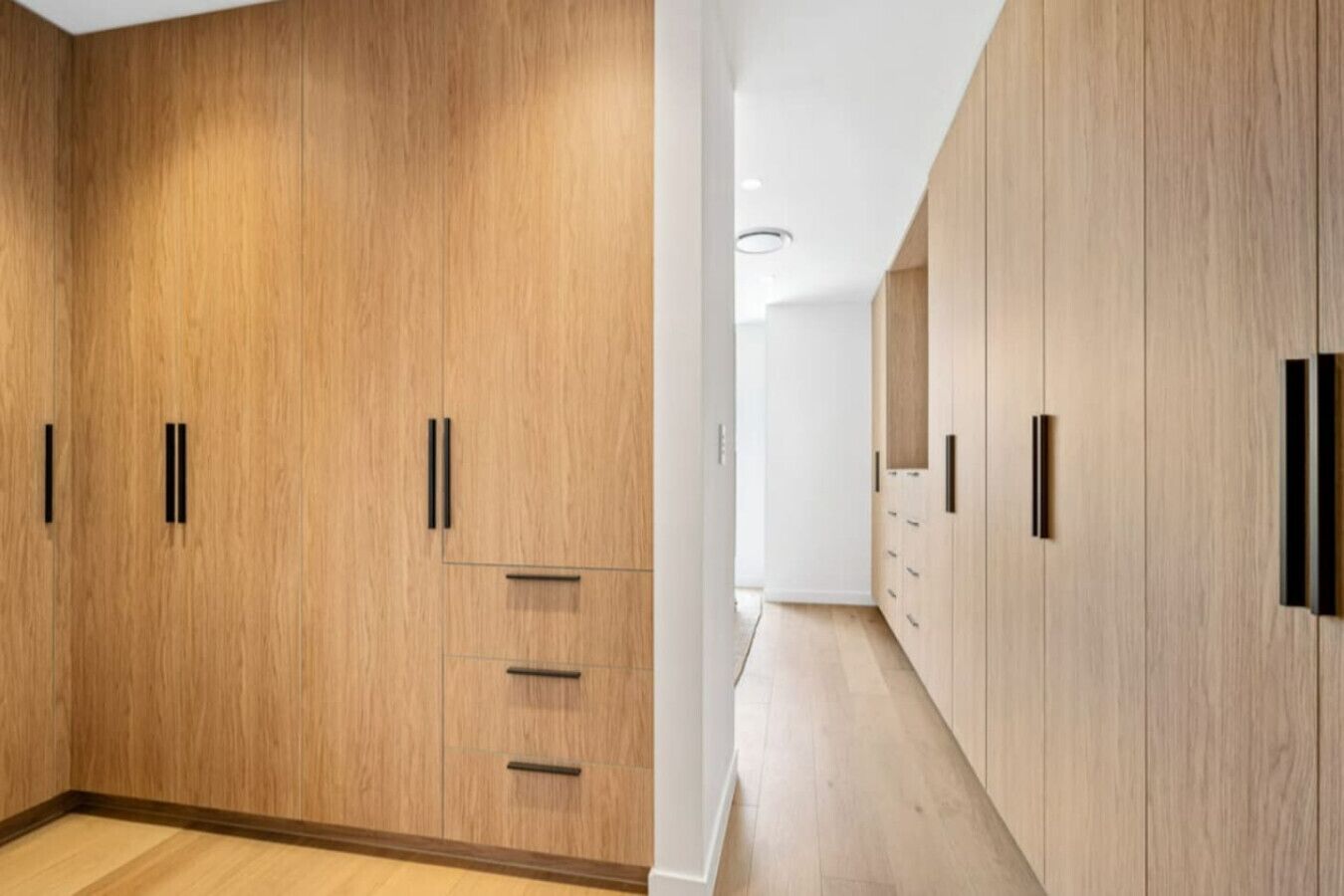 A modern room with wooden wardrobes and a minimalist design.