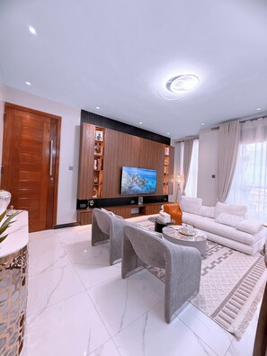 Comfort Apartment, Balcony, City View | Living area | Flat-screen TV - Ivys Cozy Homes Kampala (Kampala)
