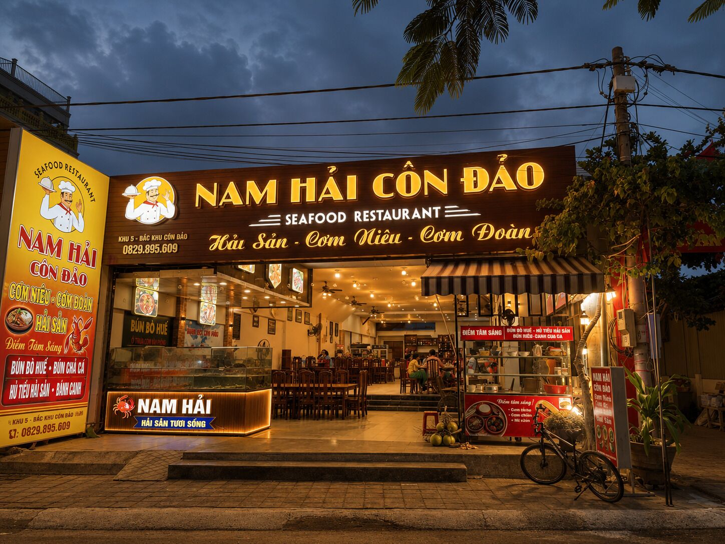 A seafood restaurant with a neon sign, outdoor seating, and a bicycle parked outside.