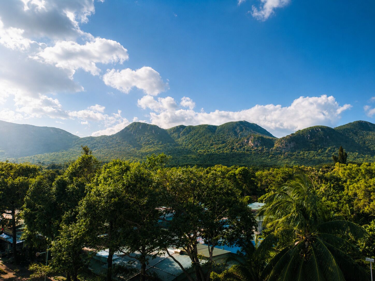A mountainous landscape with lush greenery and a clear sky.