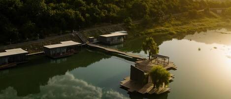 A lakeside property with floating houses connected by walkways.