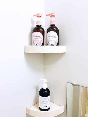 Two bottles of 'Vitaming' moisturizing treatment and one bottle of 'Purefeel Botanical Body Soap' on a white shelf. - Sightseeing area in Sumida-ku, walking distance to Skytree, close to the role, 1k, Max 4 people (墨田区太平2－9－5)