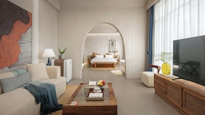 A modern hotel room with a large bed, a TV, and a coffee table with fruits and a tray. - TANG House (Wanning)