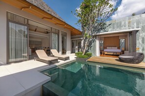 A modern house with a swimming pool, outdoor seating, and a large window overlooking the pool. - Modern 3BR Villa Kaimana Private Pool (Thep Krasattri)