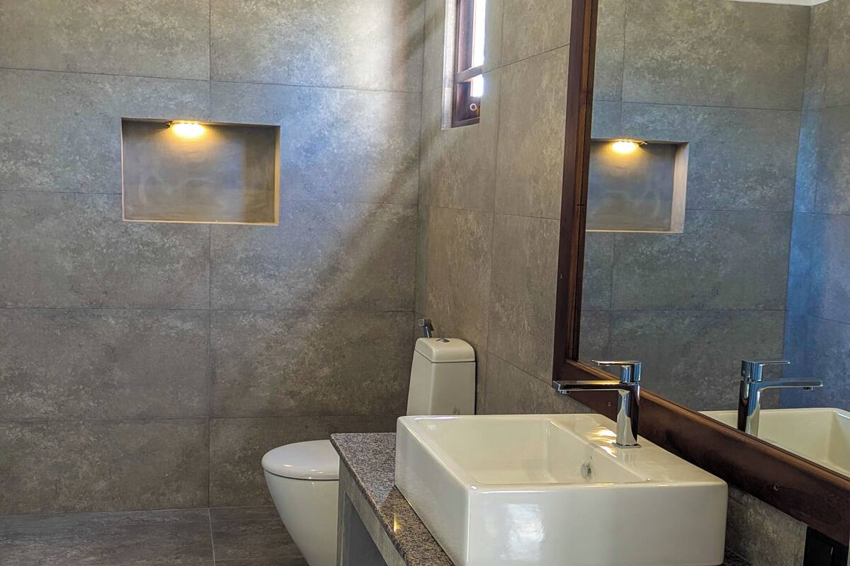 Separate tub and shower, hair dryer, slippers, towels