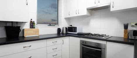 Fridge, microwave, stovetop, coffee/tea maker