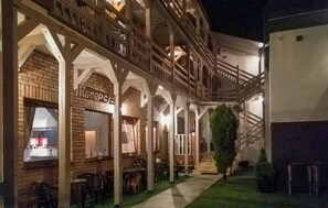 An outdoor cafe area with brick walls, wooden beams, and tables and chairs. - Gorgeous apartment in Leba with WiFi (Leba)