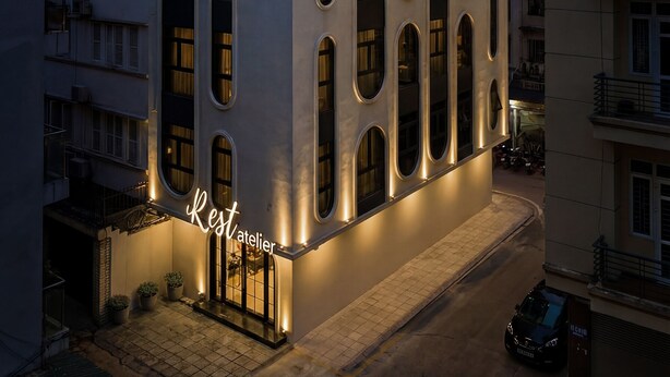 A modern building with a sign reading "Rest atelier" and the number "71" on its facade. -  iRest Atelier Hanoi Apartment & Hotel (Hanoi)