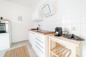 Ovn, kogeplade, kaffe-/temaskine, køkkentøj/tallerkener/redskaber