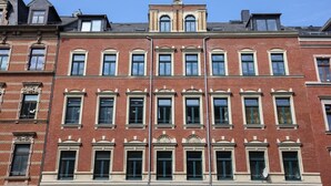 A multi-story brick building with a symmetrical facade, large windows, and a central entrance. - FullHouse | Chemnitz | M45-1 | Studio (Chemnitz)