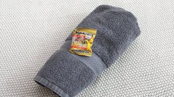 A rolled gray towel with a label reading "Haribo Goldbären."