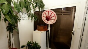 A room with a potted plant, a decorative item, and a sliding door. - Apartments Hermes (Okrug)