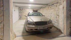 A beige Mercedes-Benz in a stone-walled garage with a concrete floor and a metal vent. - House Marijeta and Tonka (Trogir)