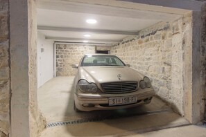 A beige Mercedes-Benz in a stone-walled garage with a concrete floor and a metal vent. - House Marijeta and Tonka (Trogir)