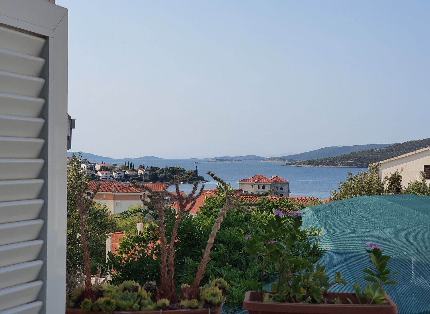 A view of a coastal town with buildings and a body of water.