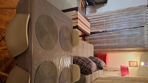 A room with a bed, a table with a unique circular design, and a patterned rug. - Apartment Branka (Zadar)
