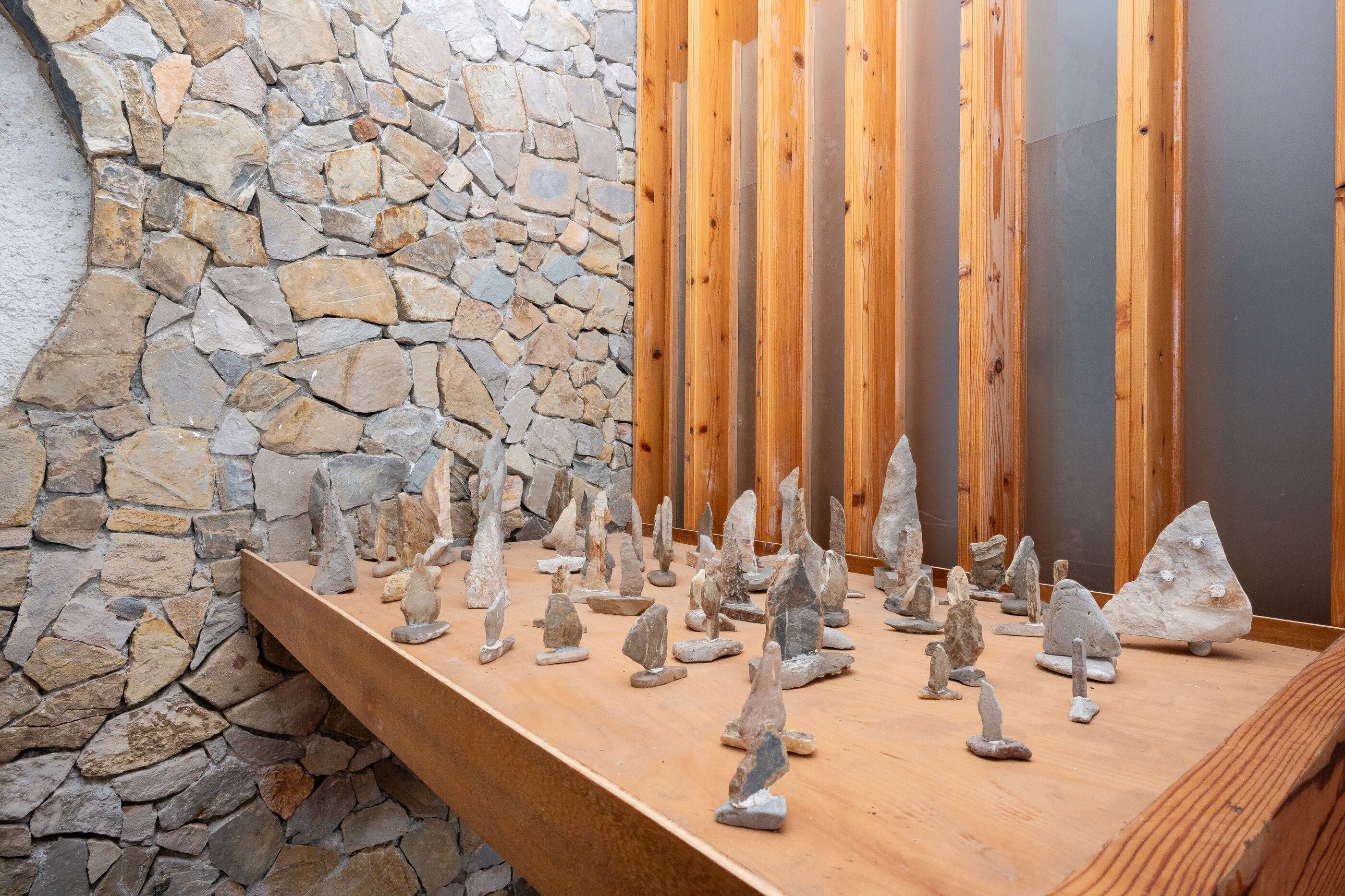 A stone wall, wooden planks, and various rock formations.