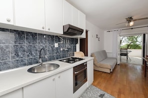 A modern kitchen with a built-in oven, a sink, and a stove. - Apartments Ema (Murter-Kornati)