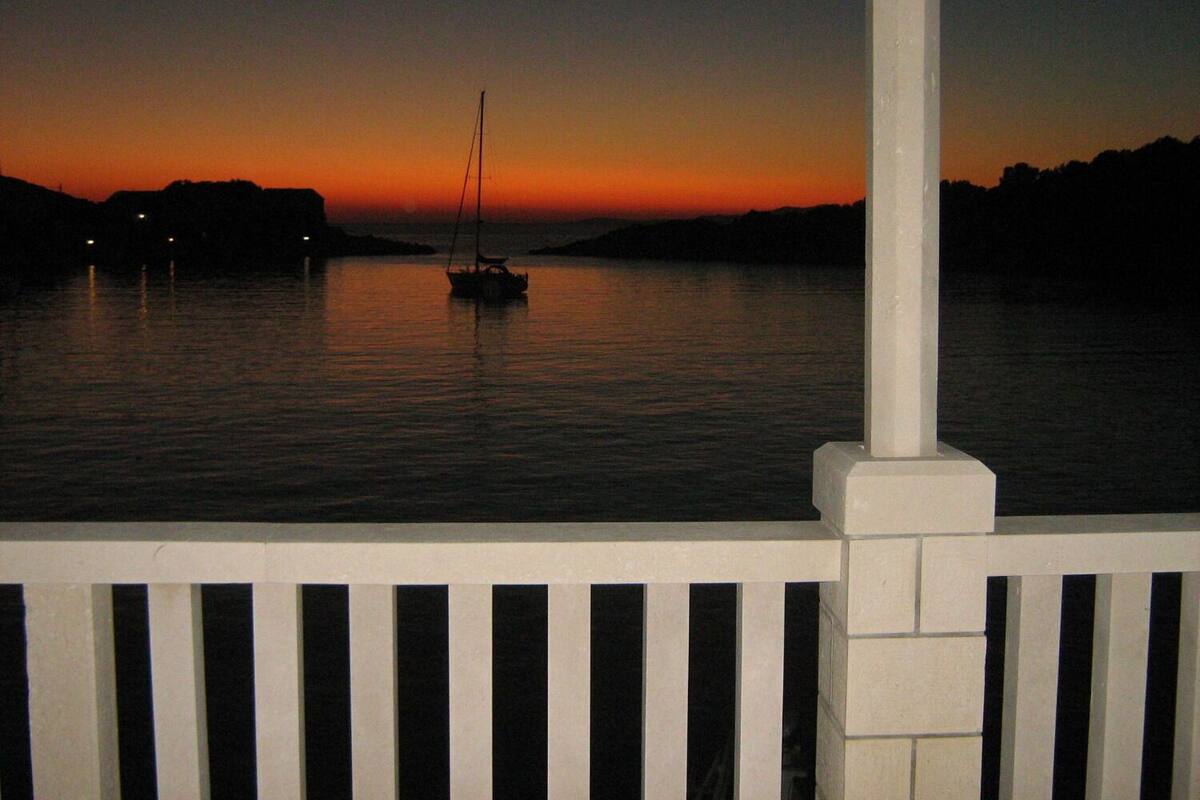 A boat on calm water during sunset.