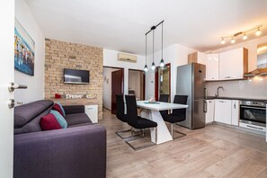 A modern apartment with a living area, dining space, and kitchen. - Apartments Dreamy (Nin)
