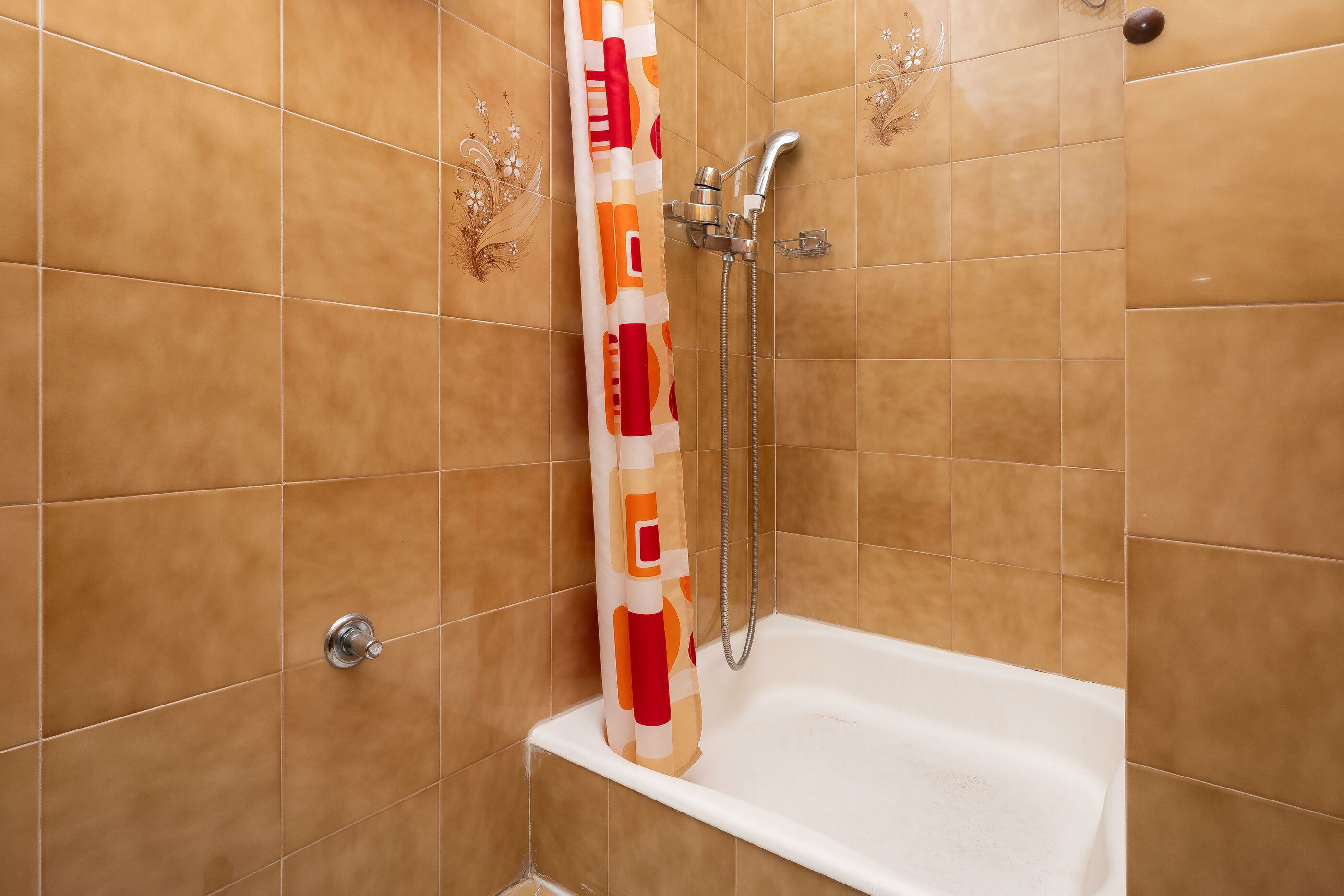 A bathroom with a shower, a bathtub, and a toilet.