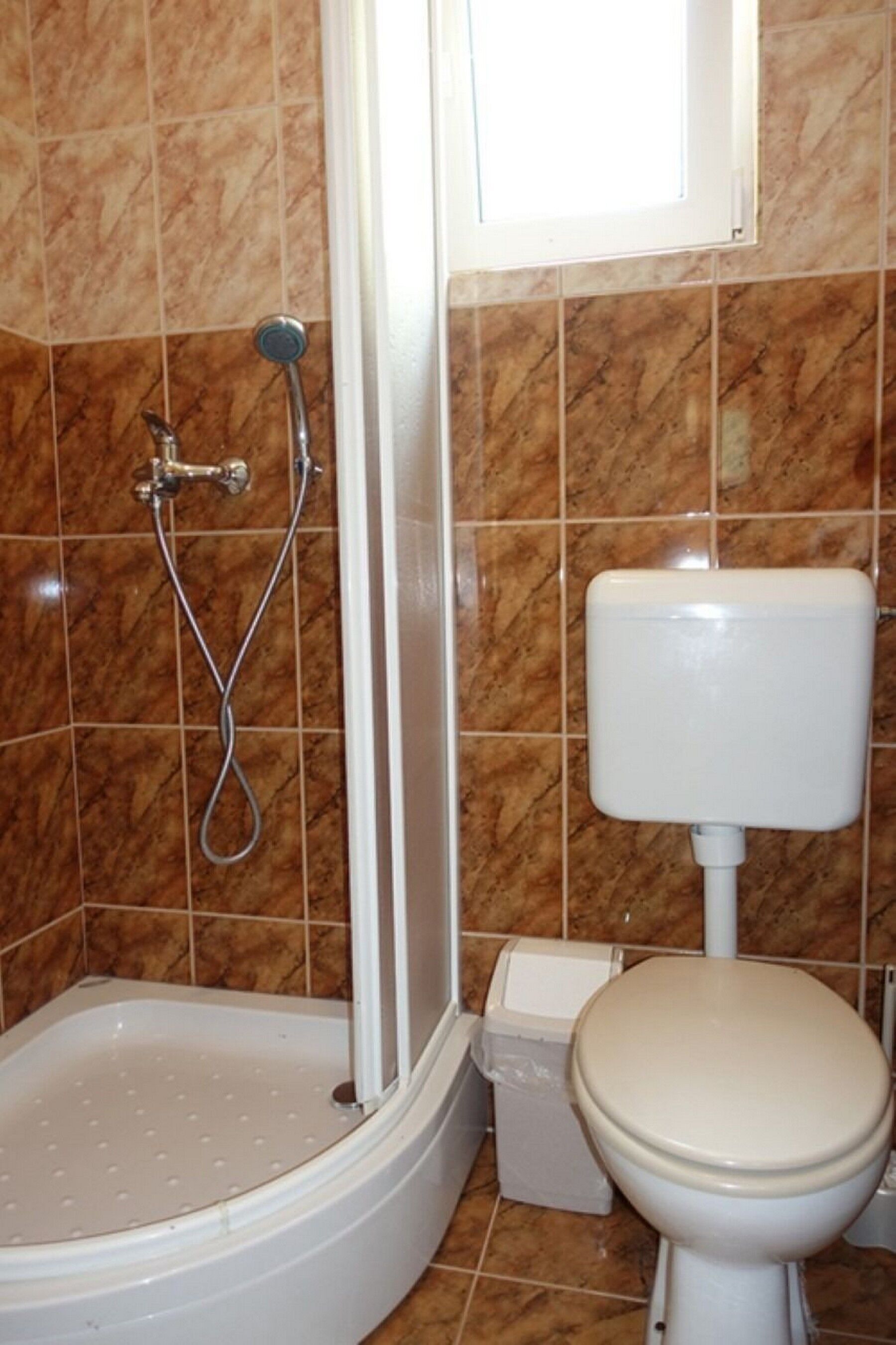 A bathroom with a bathtub, toilet, and shower.