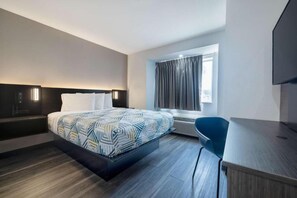 A modern hotel room with a large bed, a desk, a chair, and a window with curtains. - Cozy Queen Bed|Pool|Free Parking (McAllen)