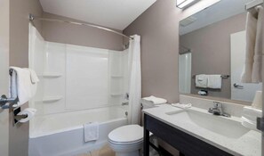 A bathroom with a shower, toilet, sink, and a mirror. - Cozy Queen Bed|Pool|Free Parking (McAllen)