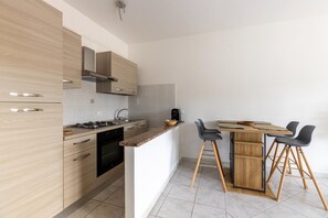 Oven, stovetop, coffee/tea maker, dining tables